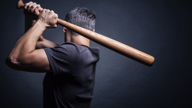 Man holding bat over shoulder free wallpaper for desktop - medium preview image