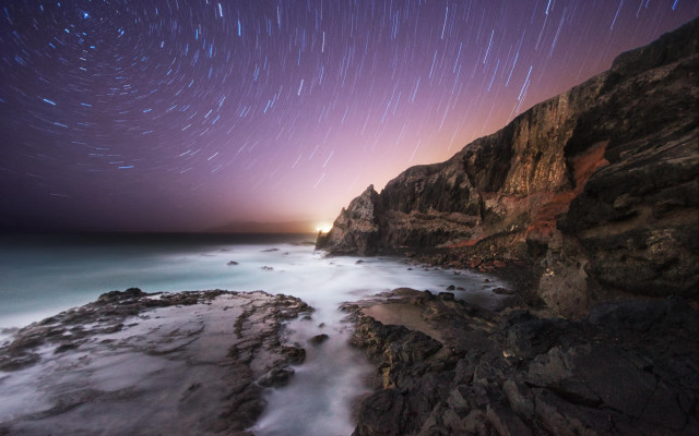 Rocky cliff starry sky beach free wallpaper for desktop - medium preview image