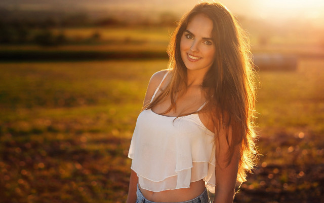 Woman field blowing hair smile free wallpaper for desktop - medium preview image