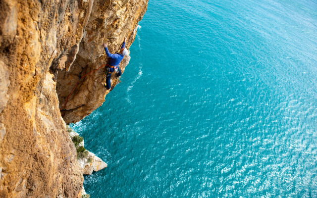 Cliff climbing man surfboard night free wallpaper for desktop - medium preview image