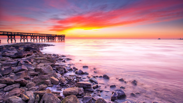 Sunset pier ocean rocks cityscape free wallpaper for desktop - medium preview image