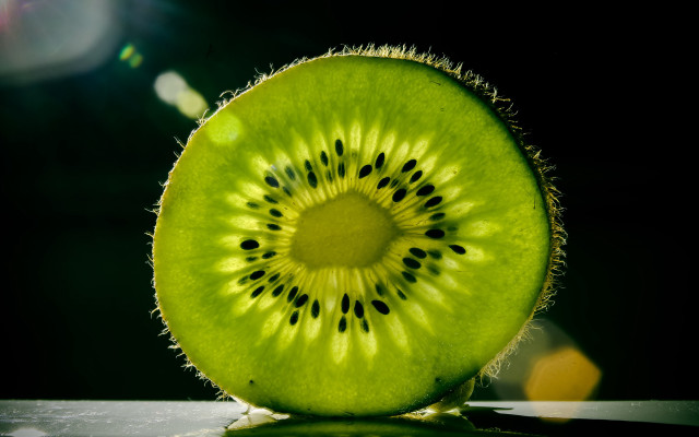 Kiwi slice tabletop black background free wallpaper for desktop - medium preview image