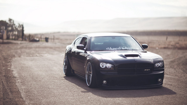 Black car driving road grass #4 free wallpaper for desktop - medium preview image