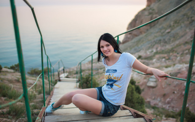 Woman ocean cliff fishing blurry free wallpaper for desktop - medium preview image