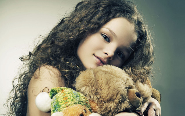 Girl holding stuffed animals smiling free wallpaper for desktop - medium preview image