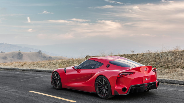 Red sports car hill road free wallpaper for desktop - medium preview image