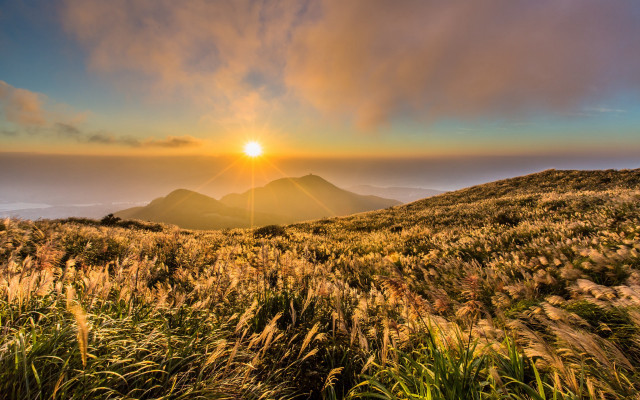 Sunset grassy hill mountain clouds free wallpaper for desktop - medium preview image