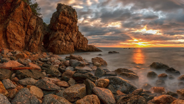 Rocky beach sunset surfboard mountains free wallpaper for desktop - medium preview image