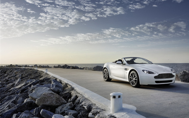 White sports car ocean rocks free wallpaper for desktop - medium preview image
