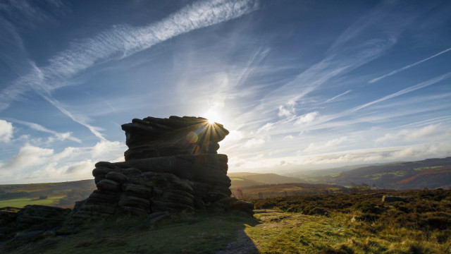 Rock formation grassy hill sunlight free wallpaper for desktop - medium preview image