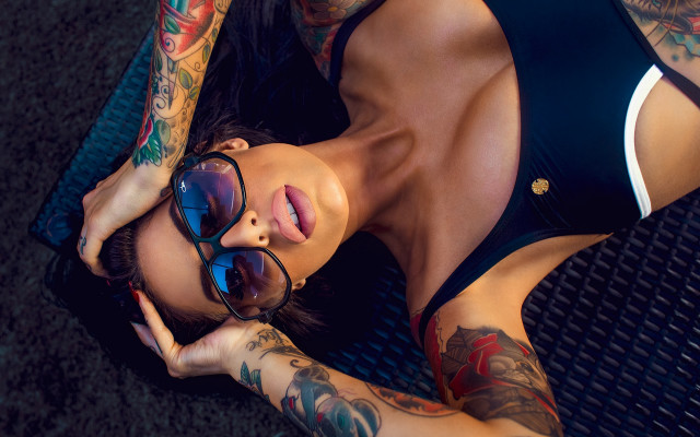 Tattooed woman laying sunglasses armor free wallpaper for desktop - medium preview image