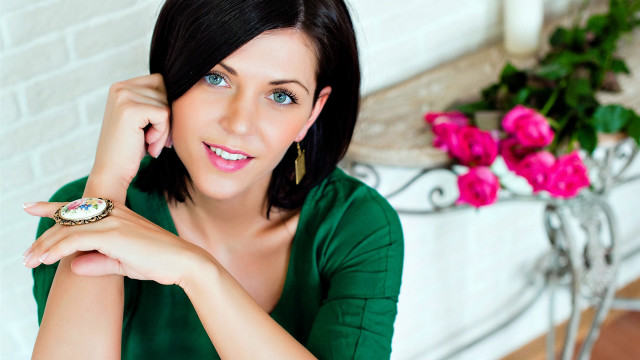 Woman smiling green shirt watch free wallpaper for desktop - medium preview image