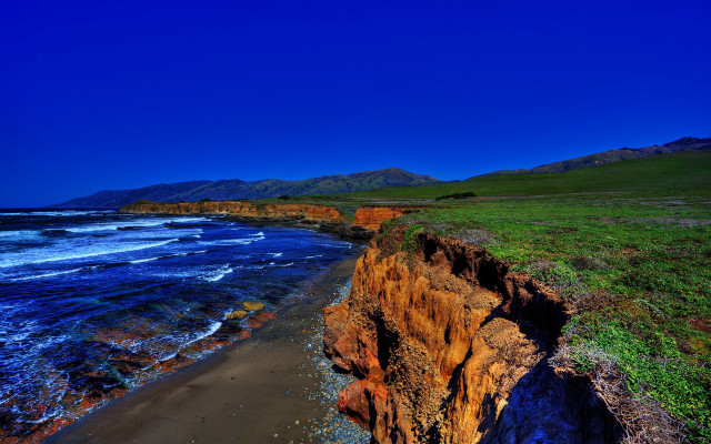 Cliff beach grassy watercity sky free wallpaper for desktop - medium preview image