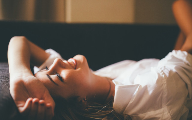 Woman laying blurry photorealistic indoor free wallpaper for desktop - medium preview image