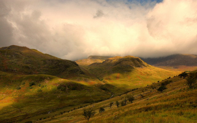 Grassy field mountains cloudy sky #2 free wallpaper for desktop - medium preview image