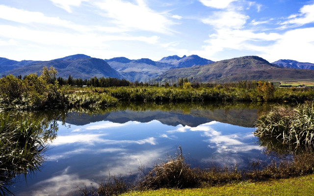 Lake mountains grass clouds sky free wallpaper for desktop - medium preview image