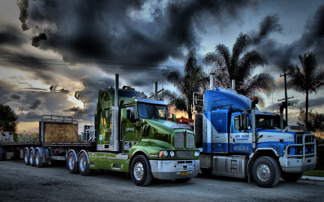 Semi trucks parked cloudy sky free wallpaper for desktop - medium preview image