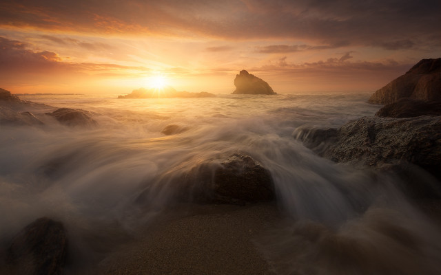Sunset rocky beach waves distant free wallpaper for desktop - medium preview image