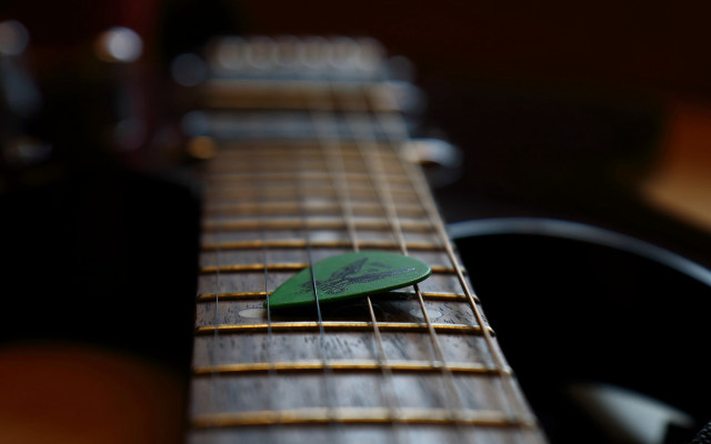 Green guitar pick on guitar free wallpaper for desktop - medium preview image