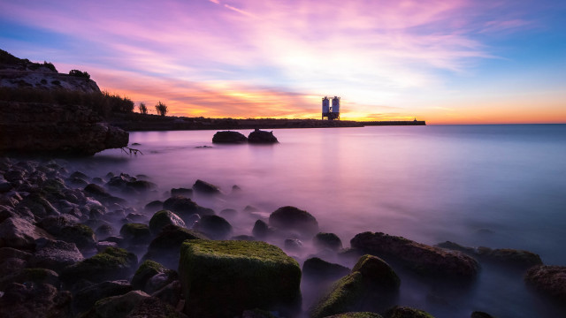 Sunset rocky beach lighthouse mystical free wallpaper for desktop - medium preview image