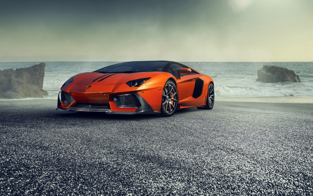 Orange sports car ocean rock free wallpaper for desktop - medium preview image