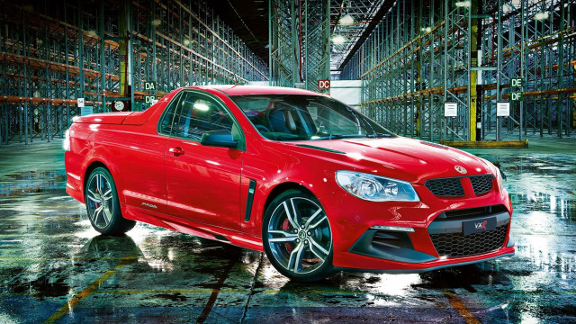 Red car warehouse pallets cityscape free wallpaper for desktop - medium preview image