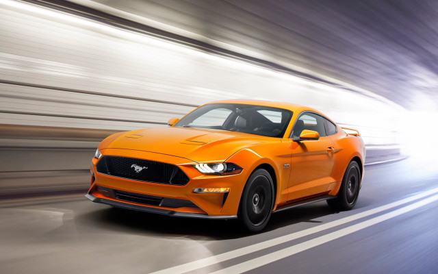 Bright orange mustang driving blurry free wallpaper for desktop - medium preview image