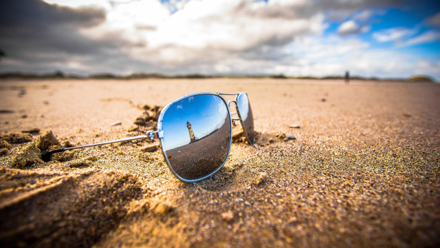 Sunglasses beach sand clouds ocean free wallpaper for desktop - medium preview image