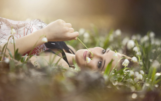 Woman laying grass flower mouth free wallpaper for desktop - medium preview image