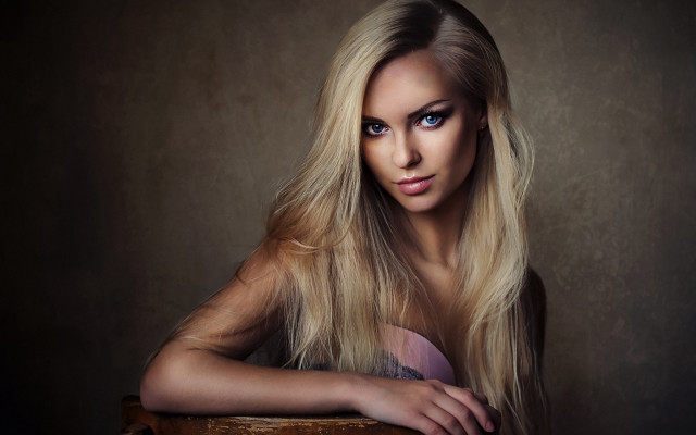 Serious blonde woman chair portrait free wallpaper for desktop - medium preview image