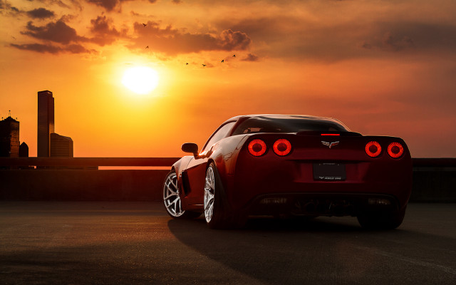 Red sports car sunset backlit free wallpaper for desktop - medium preview image