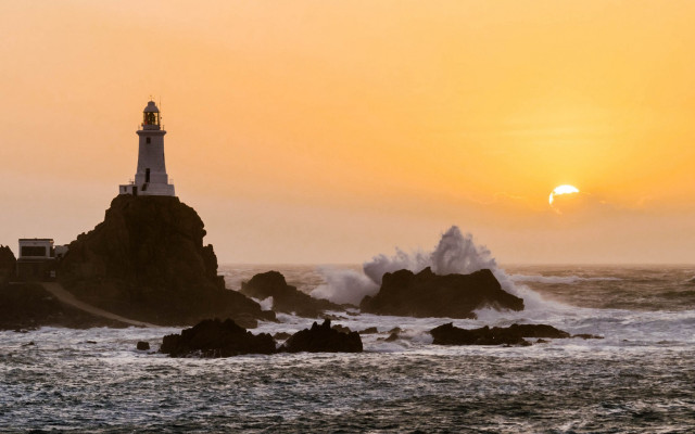 Lighthouse rocky shore waves sunset free wallpaper for desktop - medium preview image