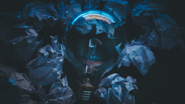 Person lightbulb crumpledpaper bluelight blackbackground free wallpaper for desktop - medium preview image