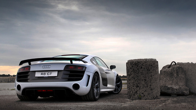 White sports car rock formation free wallpaper for desktop - medium preview image