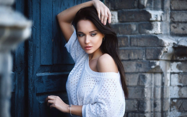 Woman white top brick wall free wallpaper for desktop - medium preview image