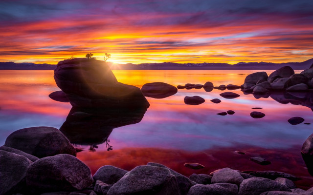 Sunset lake rocks water person free wallpaper for desktop - medium preview image