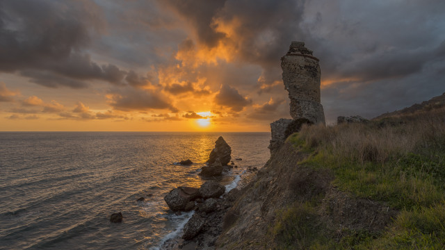 Sunset rocky cliff grassy hill free wallpaper for desktop - medium preview image