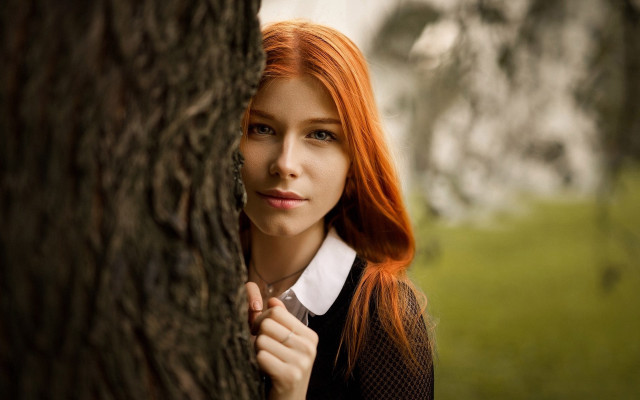 Redhair leaning against tree serious free wallpaper for desktop - medium preview image
