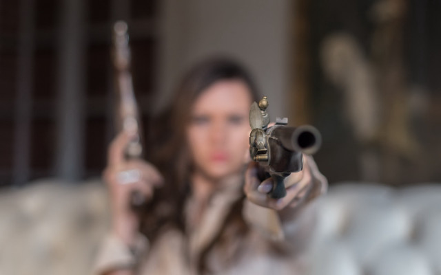 Woman gun blurry background pov free wallpaper for desktop - medium preview image