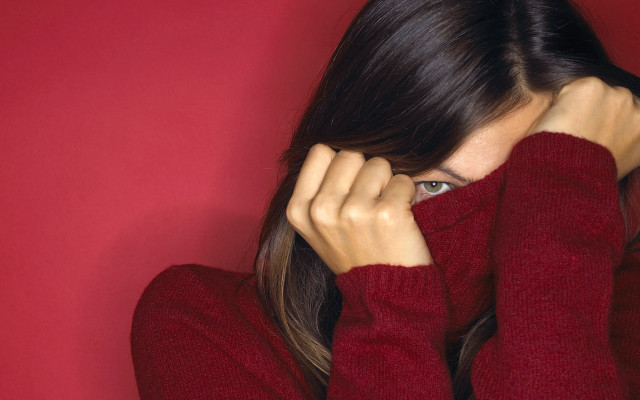 Woman in red sweater covering free wallpaper for desktop - medium preview image