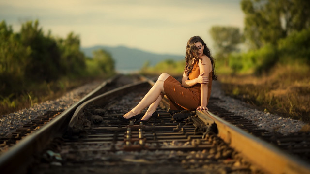 Woman sitting train track bokeh free wallpaper for desktop - medium preview image