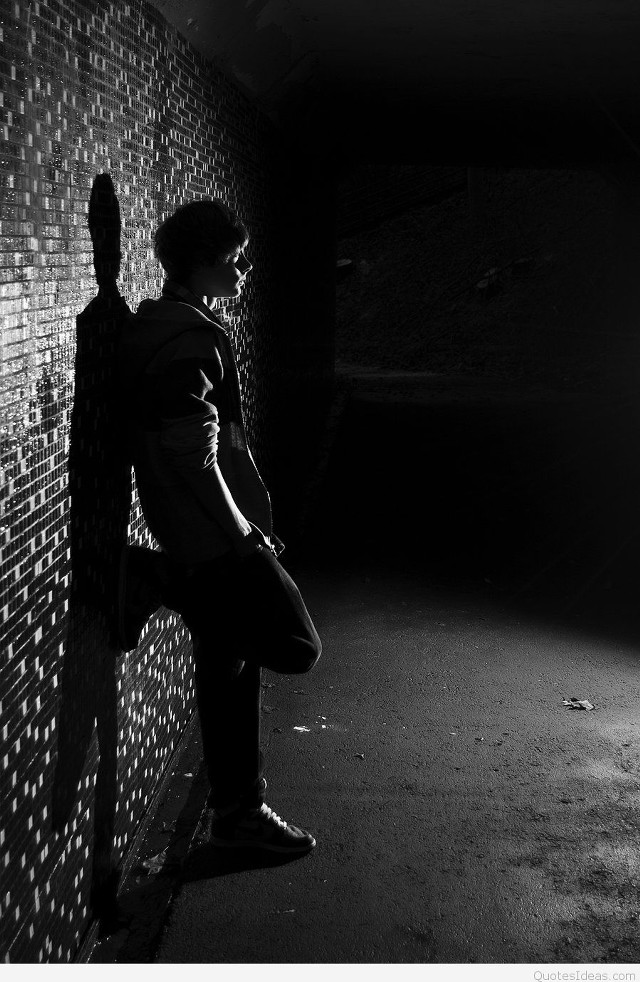 Man leaning brick wall dark free wallpaper for mobile - medium preview image