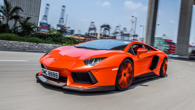 Bright orange sports car city #2 free wallpaper for desktop - medium preview image