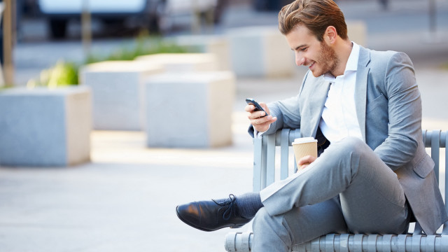 Man sitting coffee cellphone blurry free wallpaper for desktop - medium preview image