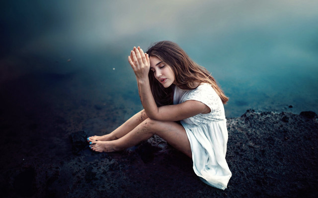 Woman sitting rock hands covered free wallpaper for desktop - medium preview image