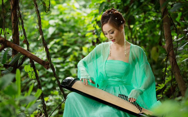 Woman green dress playing music free wallpaper for desktop - medium preview image