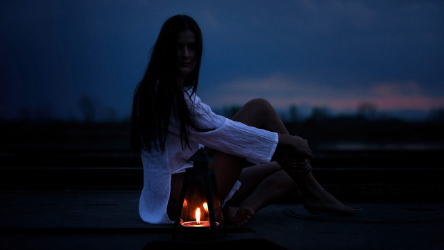 Woman sitting lantern candle night free wallpaper for desktop - medium preview image