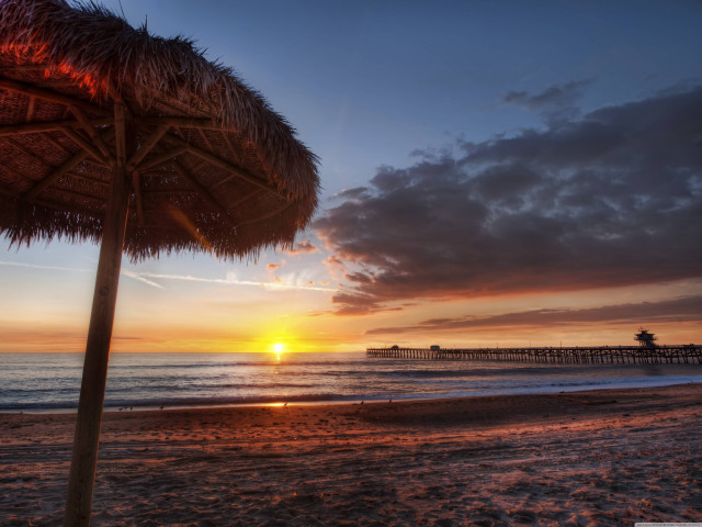 Beach sunset palm trees umbrellas free wallpaper for desktop - medium preview image