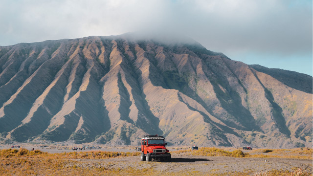 Red truck dirt road mountains free wallpaper for desktop - medium preview image