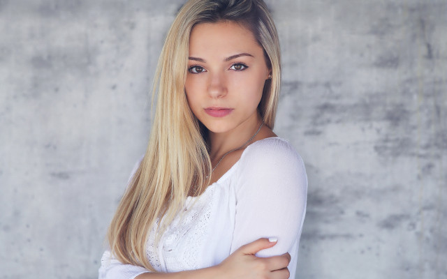 Blonde woman crossed arms concrete free wallpaper for desktop - medium preview image